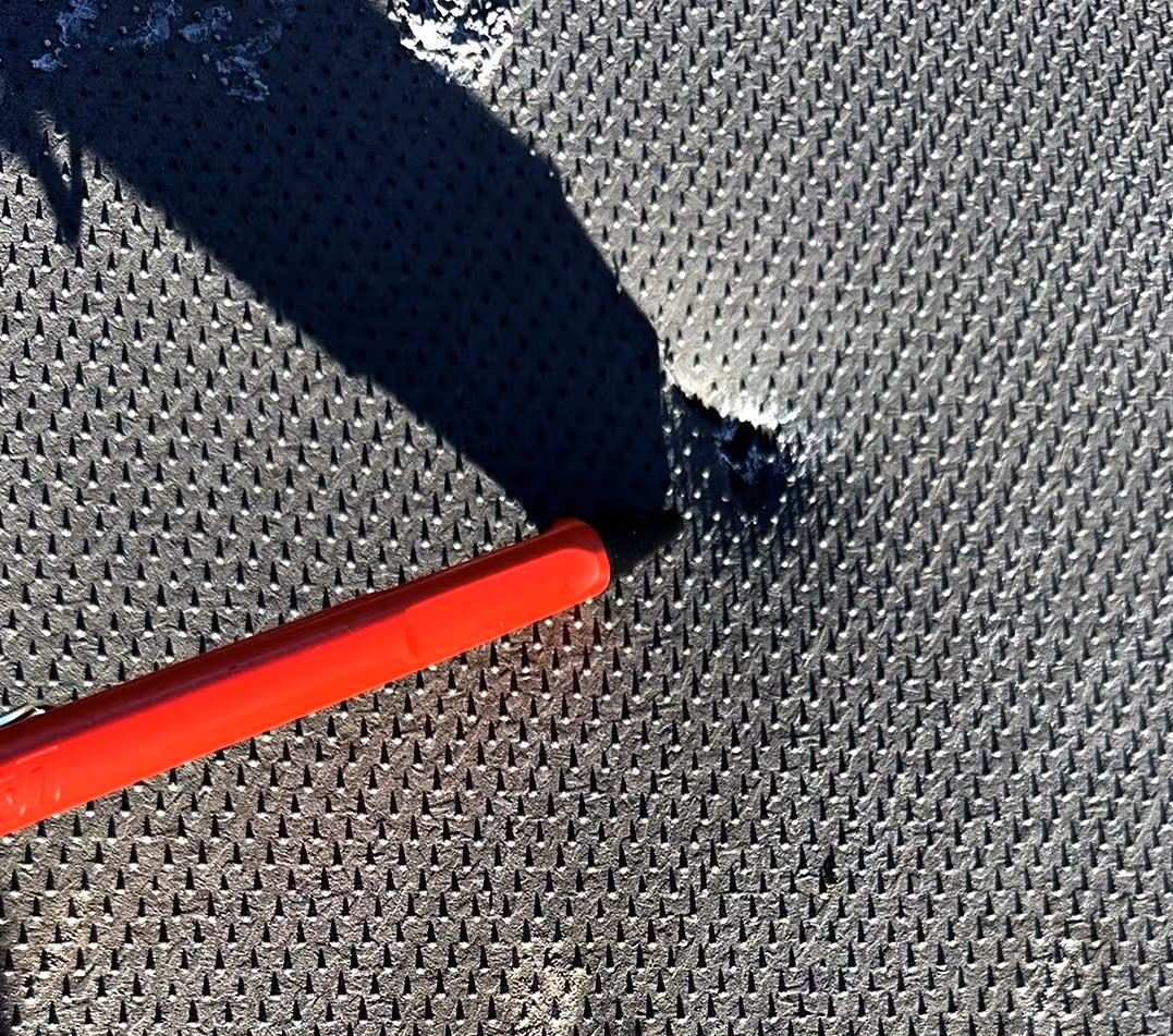 Pen pointing at hole in lining