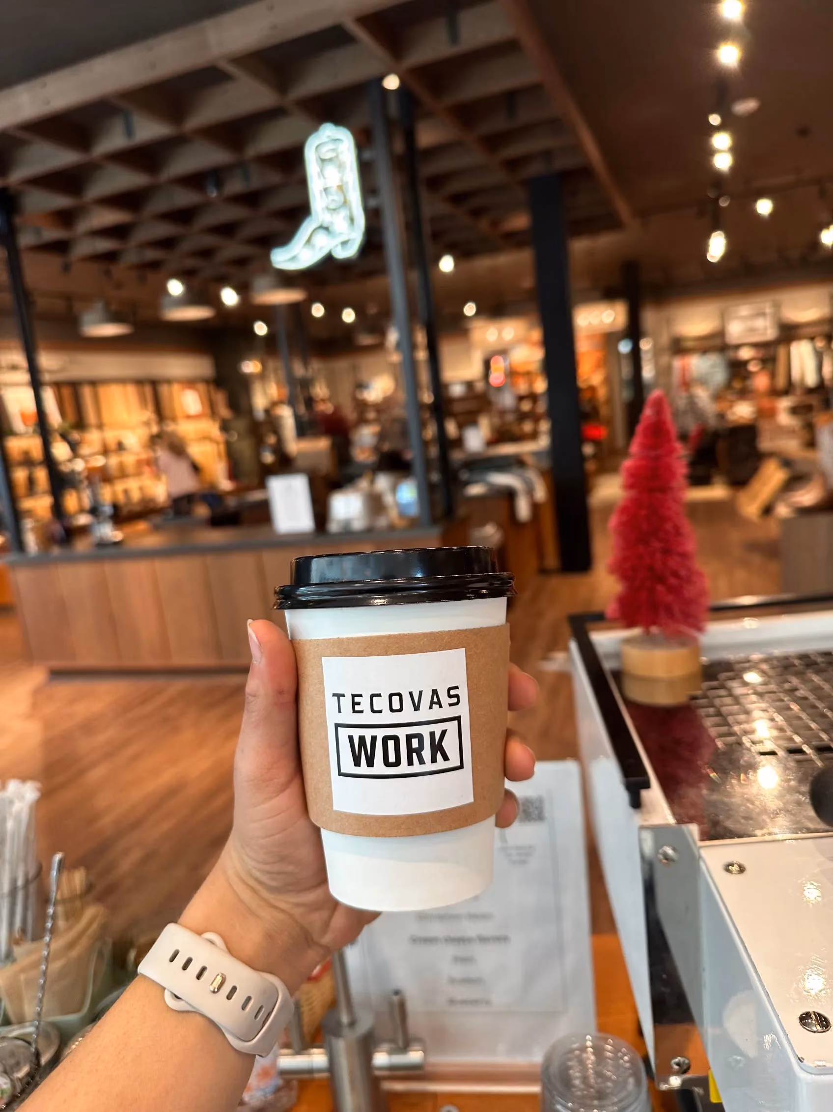 Branded Tecovas coffee cup from a Sage's Playground brand activation event