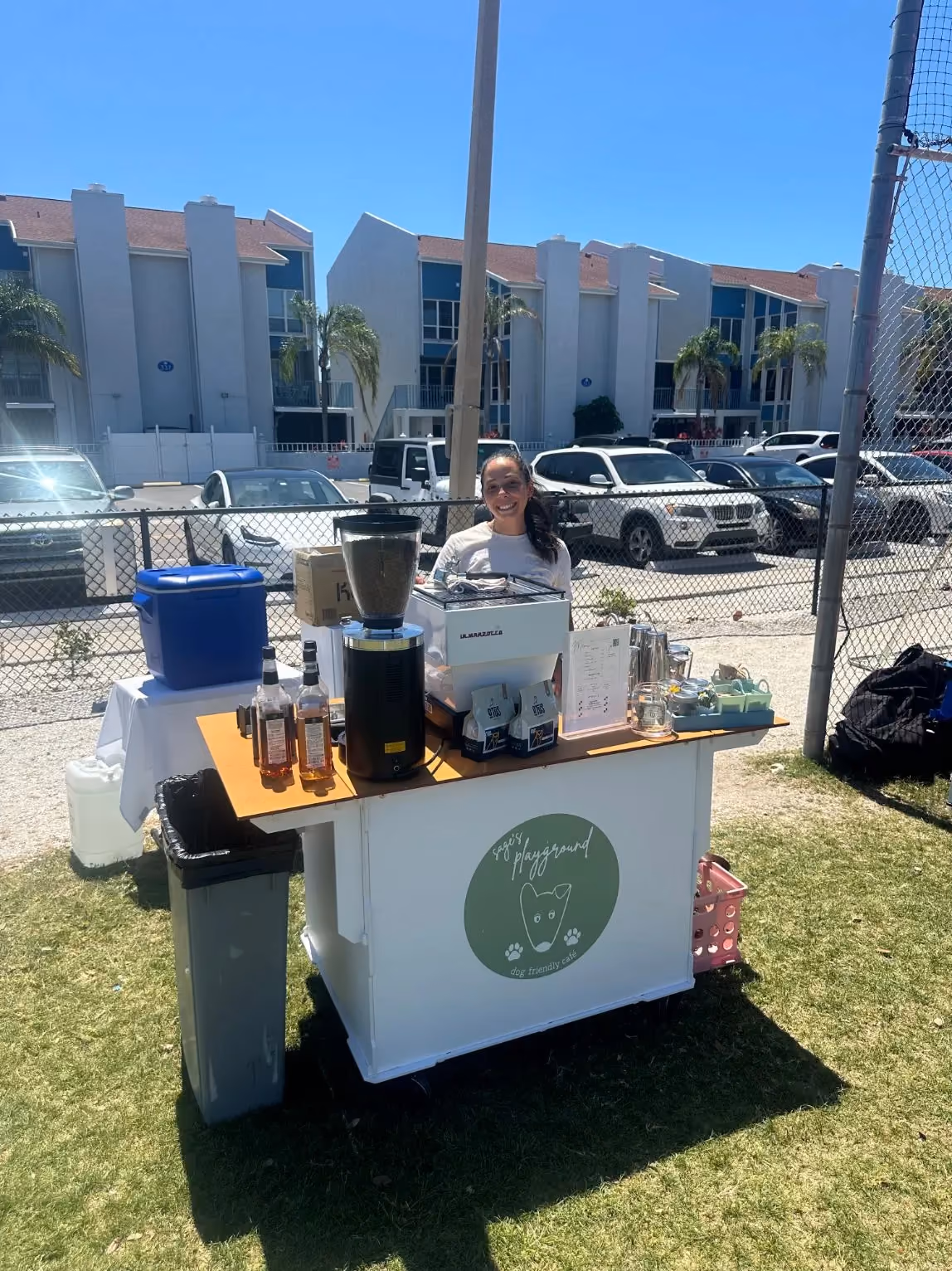 Dyllan Allen behind the Sage's Playground coffee cart at an Outdoor Group Fitness event in a Tampa Bay park