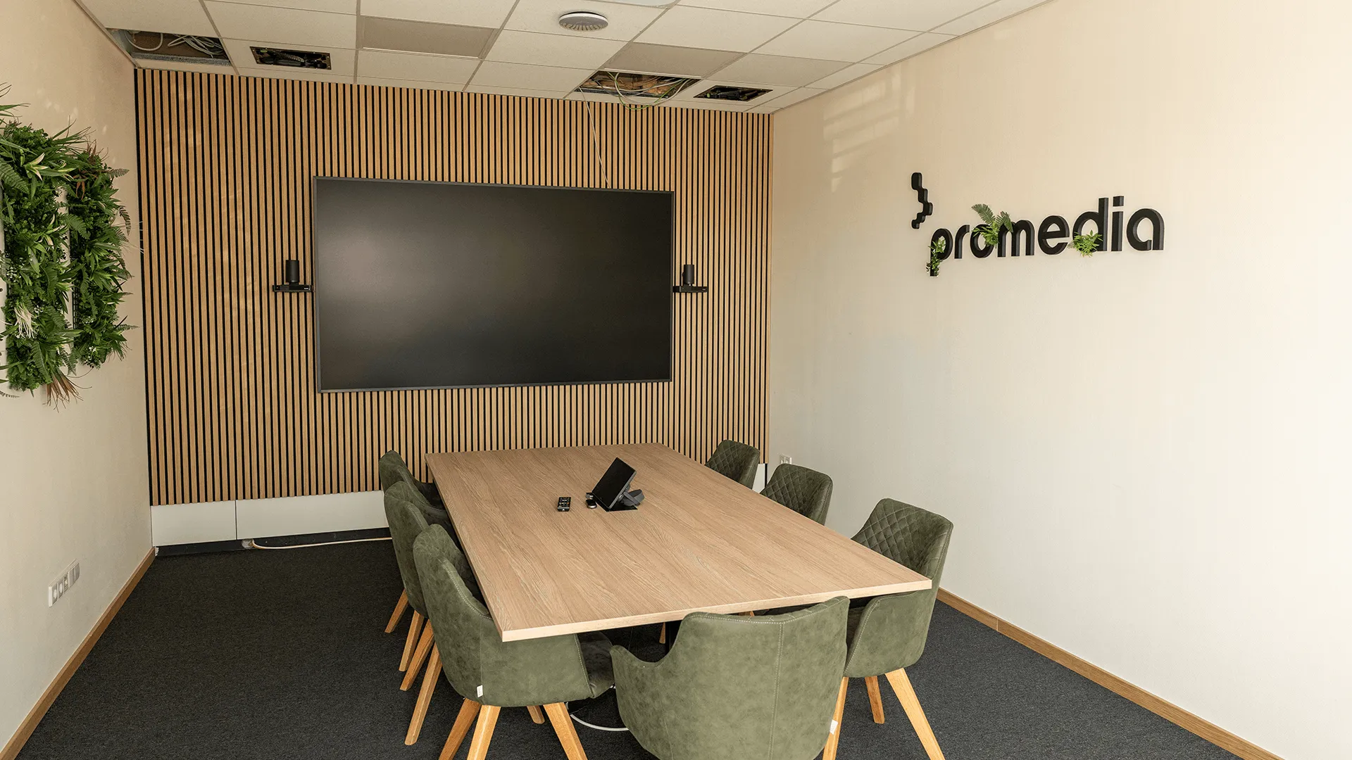 Promedia Konferenzraum-Komplettlösung – professionell ausgestatteter Meetingraum mit wandmontiertem Display, geplant und installiert von Promedia aus Hockenheim.