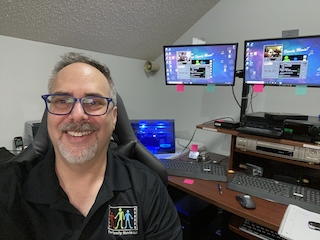 Man sitting in front of computer displays