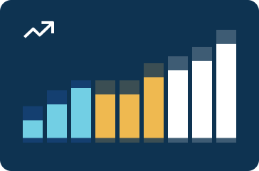 Aerial view of a wide, illuminated city intersection with multiple lanes and few cars driving at night.