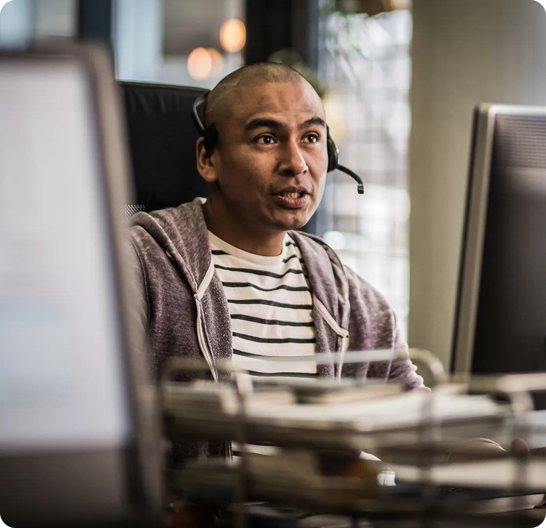An ECC dispatcher taking a call at his workstation.