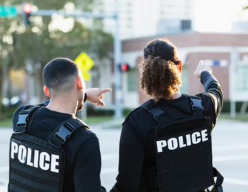Two police officers surveying a scene.
