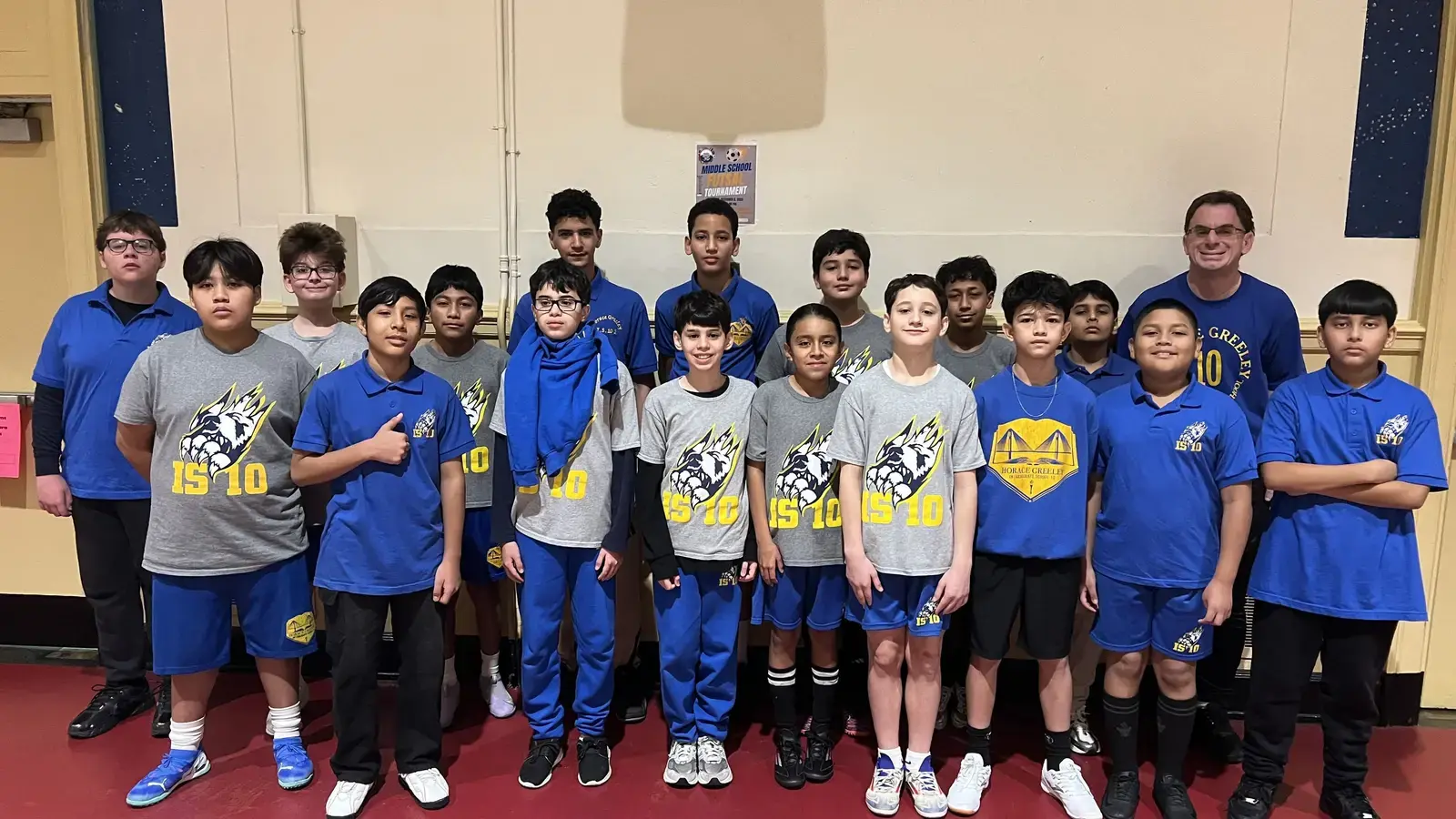 IS 10 middle school soccer team posing with coach at tournament