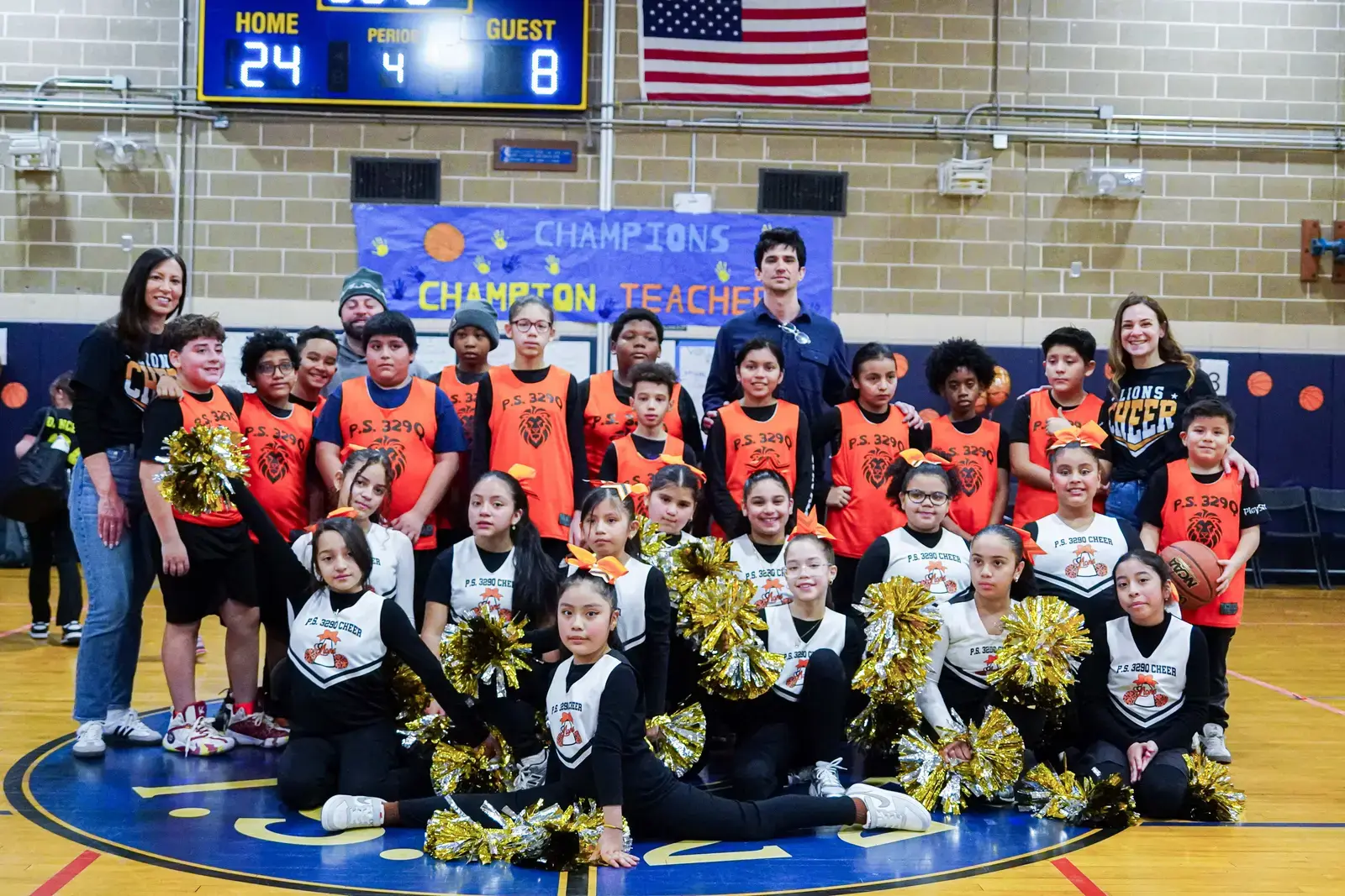 PS 3290 Lions cheer squad and basketball team pose in gymnasium