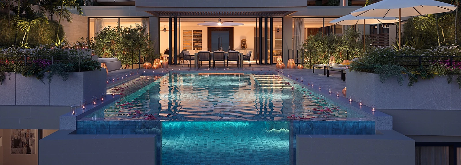 Pool frontage and outdoor dining terrace at dusk