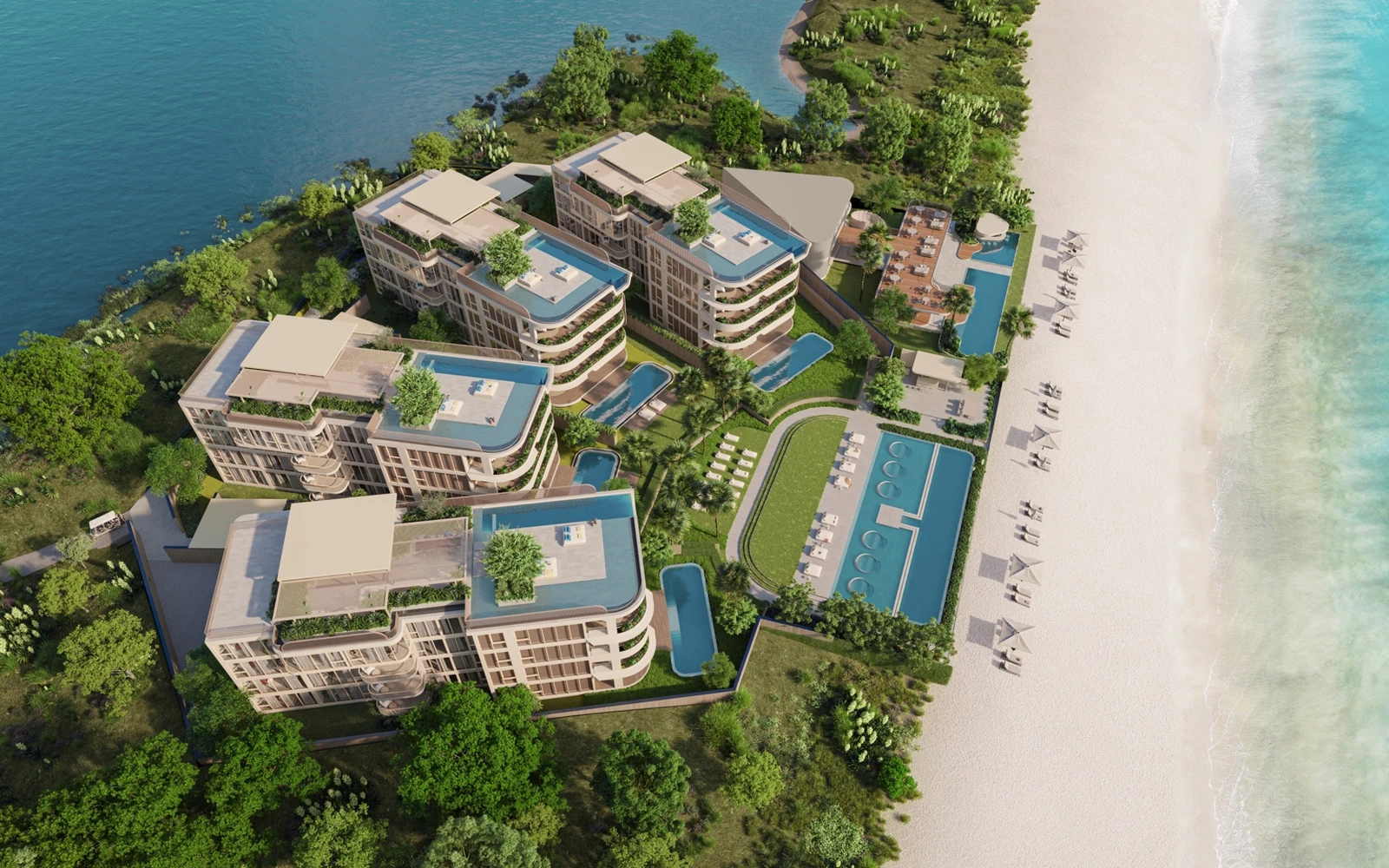 Overhead view of beachfront residences, pools, lawn, and beach