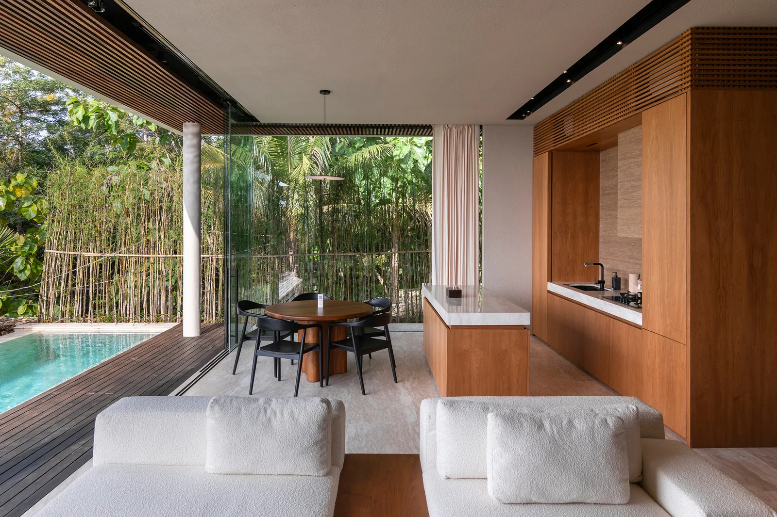 Kitchen and dining area with pool and bamboo garden outlook