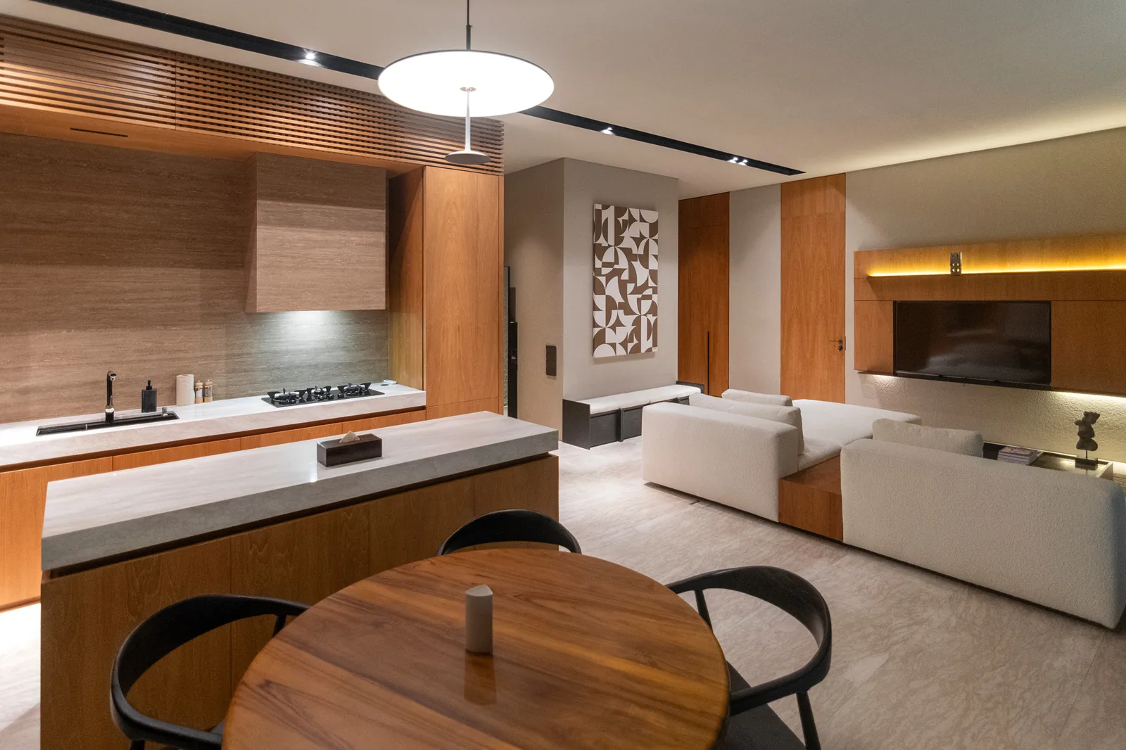 Kitchen and dining zone with open living area and wood cabinetry