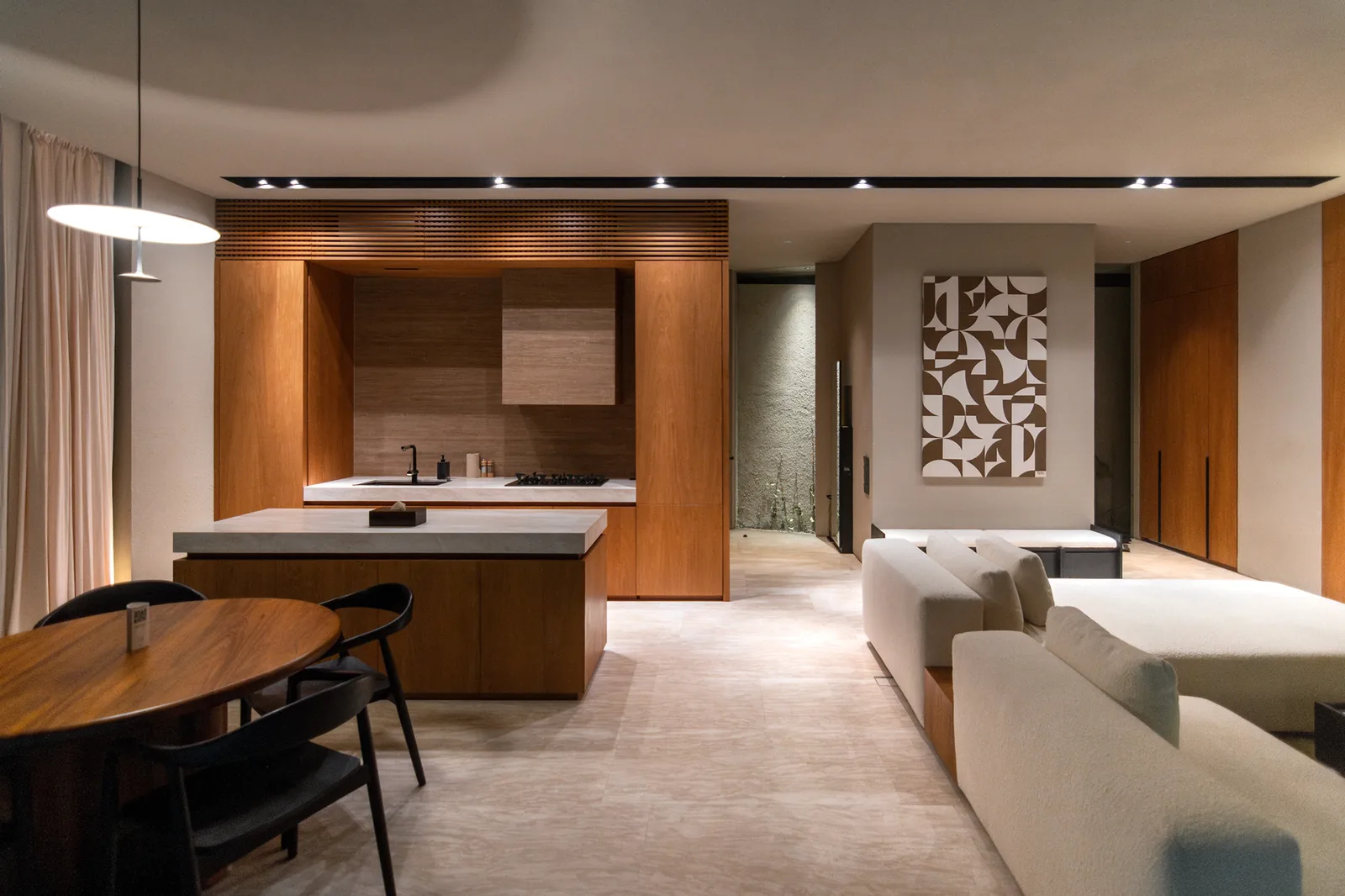 Kitchen island with dining table and living area beyond