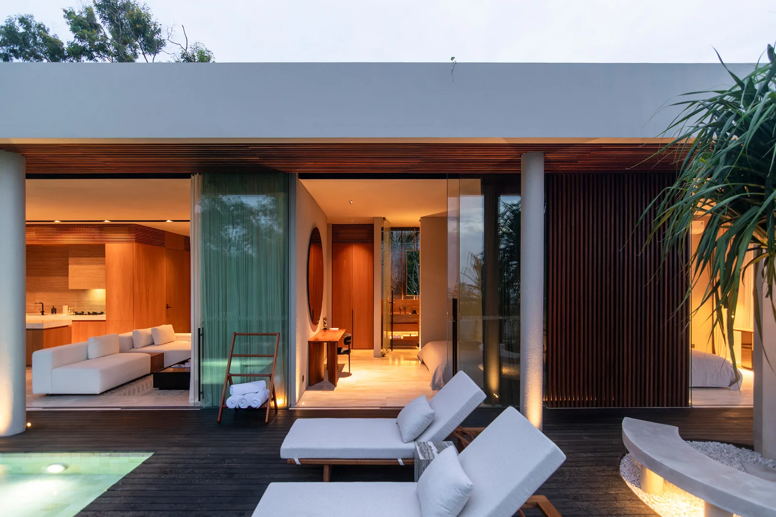 Terrace pool deck with interior rooms visible at twilight