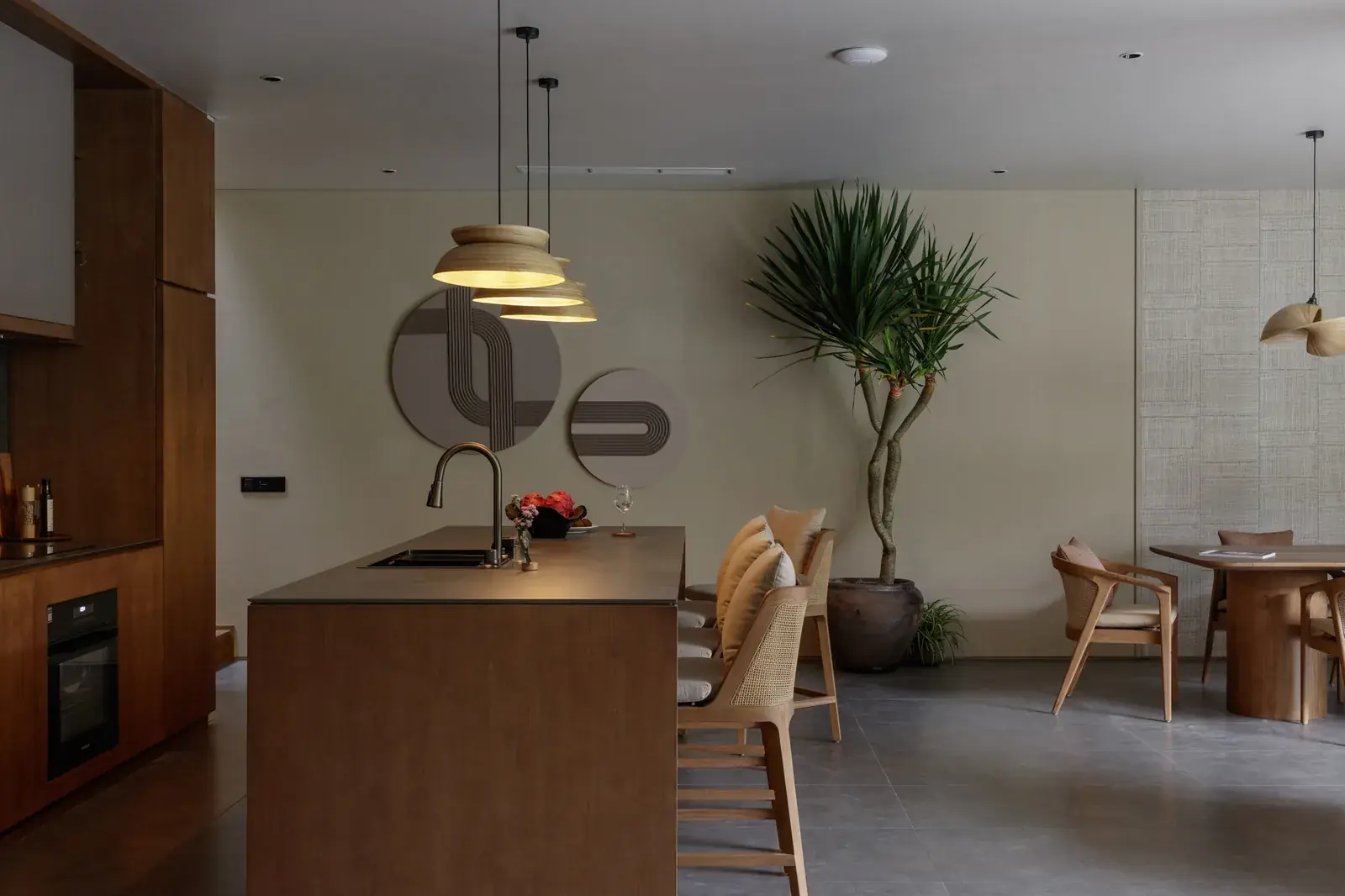 Open-plan kitchen and dining area with warm timber joinery