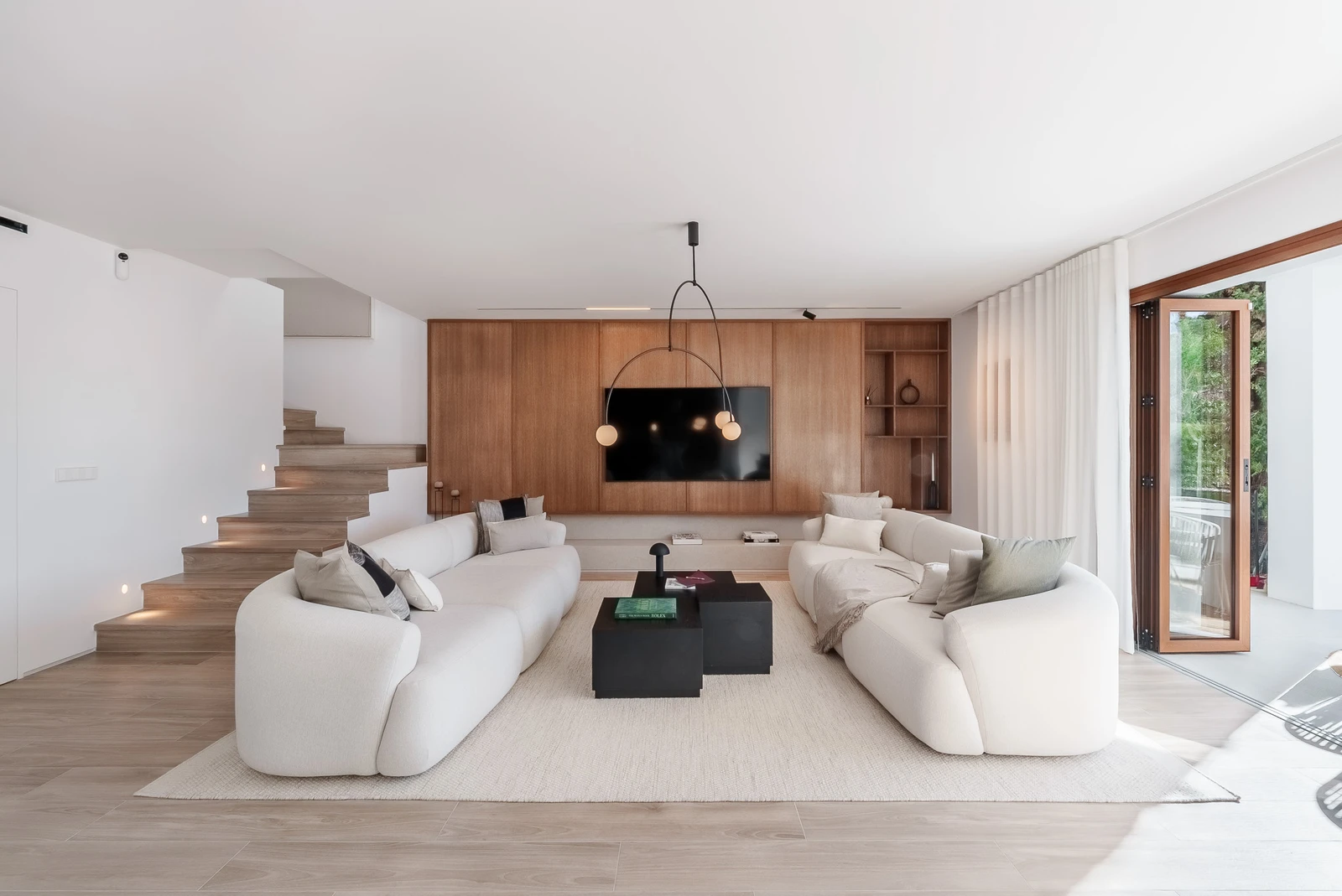 Living room with terrace access and wood paneling