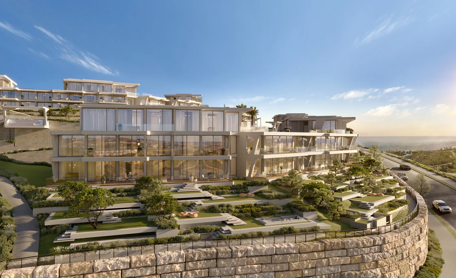 Marea Missoni garden unit exterior with glass curtain wall and terraced landscaped gardens at sunset, Casares