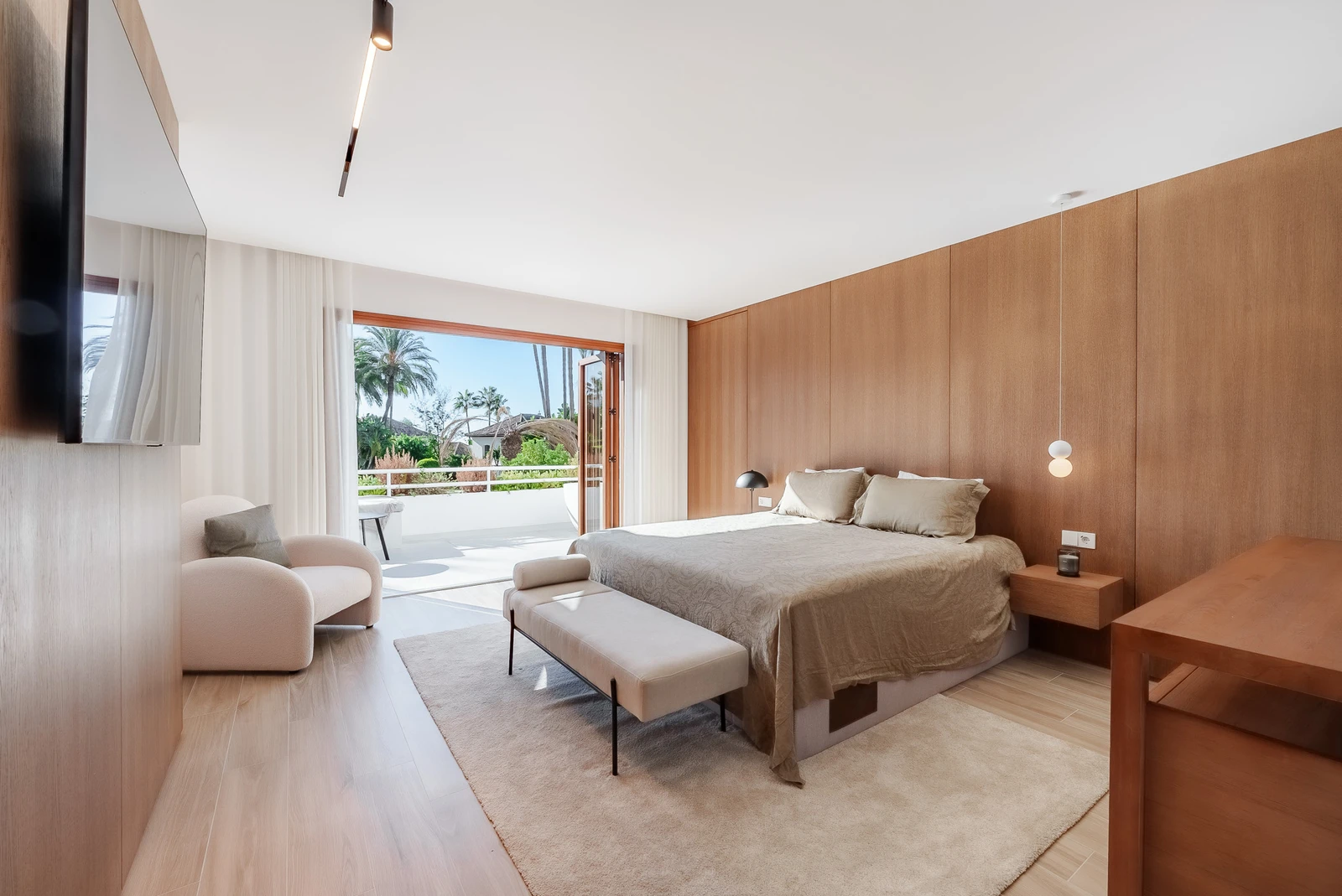 Bedroom opening to a terrace overlooking the pool