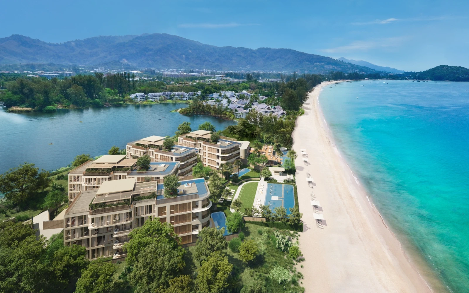 Oblique aerial view of beachfront residences with beach and lagoon