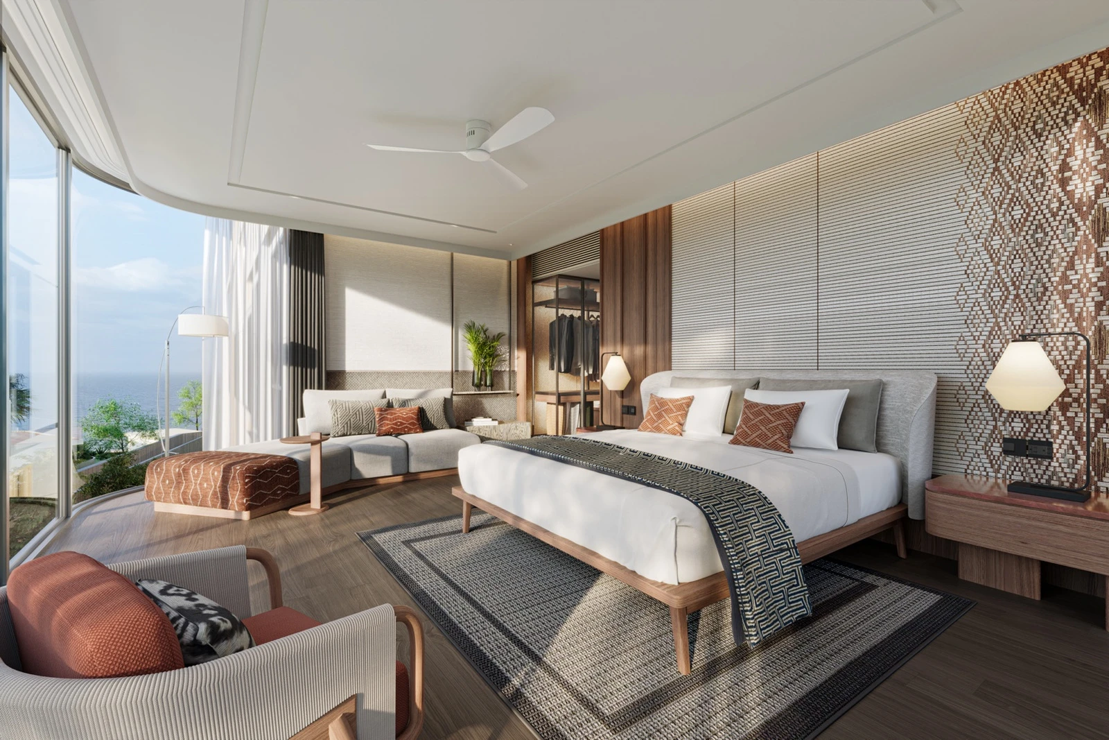 Primary bedroom with seating area and partial ocean view