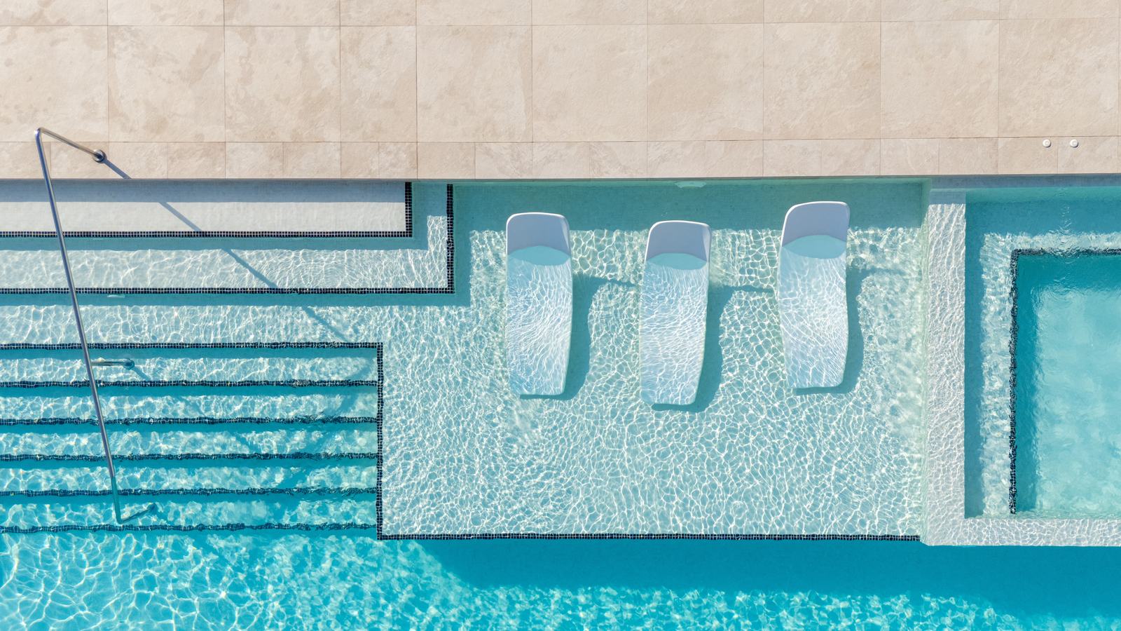 Aerial view of a wellness-led luxury residence with a pool and cold-plunge