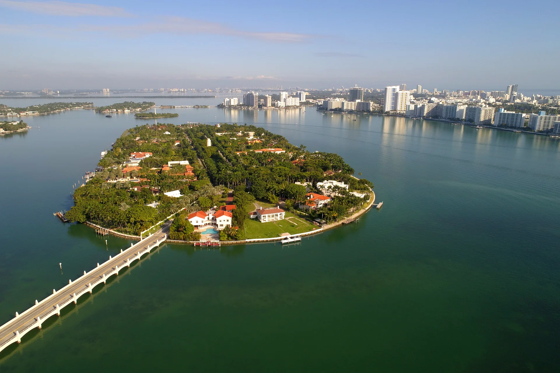 Aerial view of Star Island, Miami Beach - guard-gated waterfront estates on a single loop road in Biscayne Bay, connected by one bridge to the MacArthur Causeway