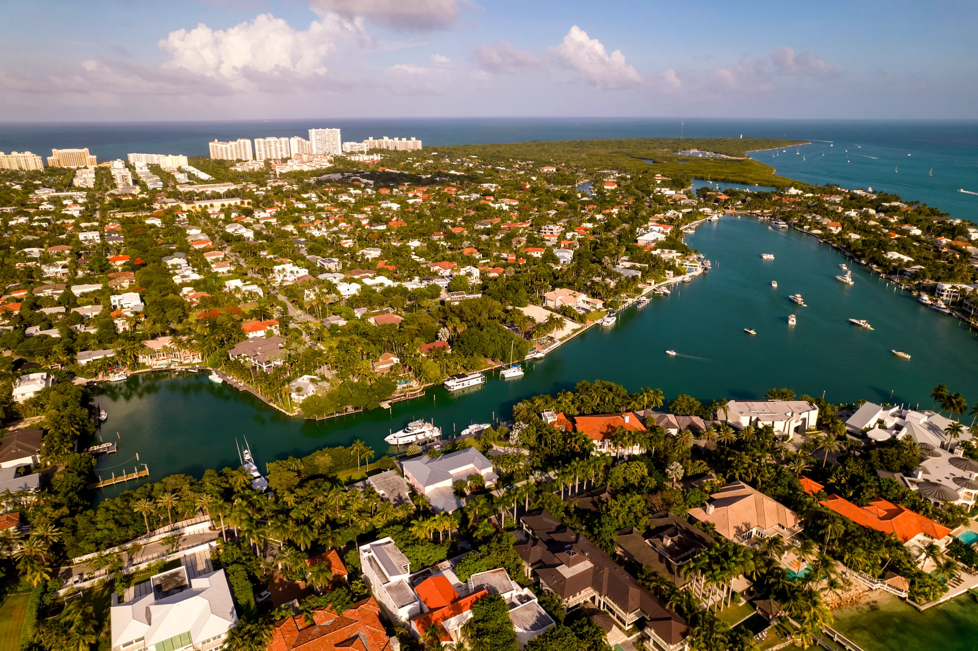 Aerial view of Key Biscayne, Miami - waterfront homes around Hurricane Harbor with boats at anchor and the island's beaches and parkland beyond