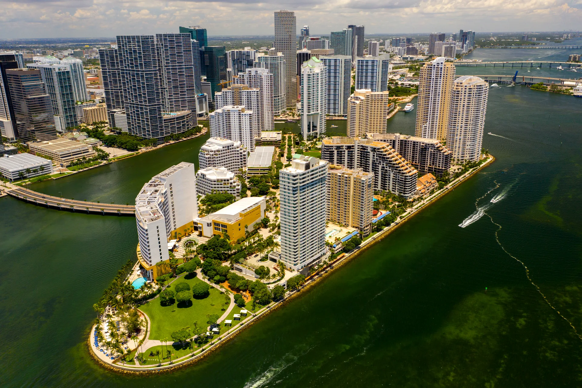 Aerial view of Brickell Key, Miami - condo towers and green parkland on a triangular private island connected to Brickell by a single bridge
