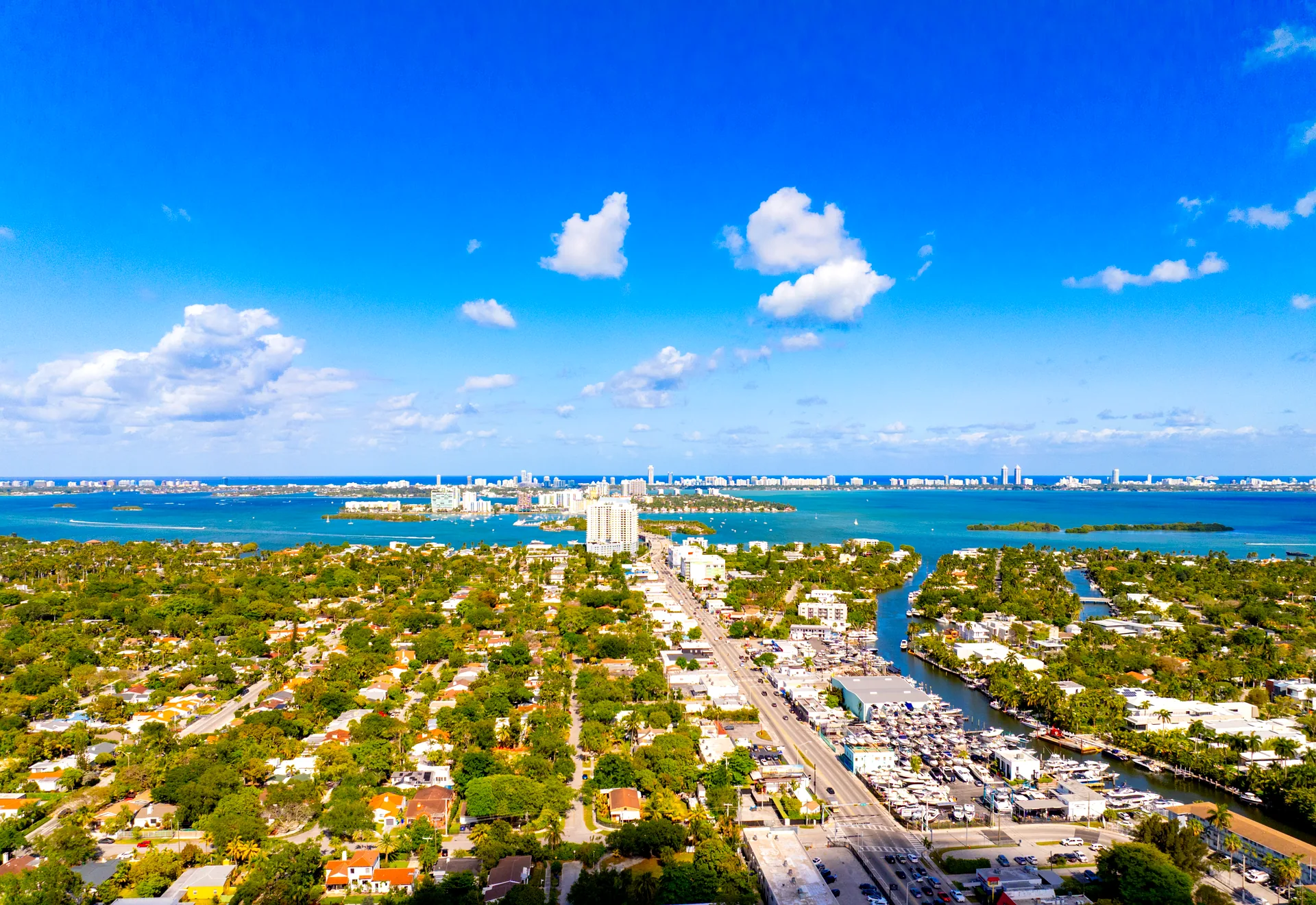 View across Biscayne Bay toward North Bay Village, Miami - mid-bay island towers between the mainland canals and the Miami Beach skyline on the horizon
