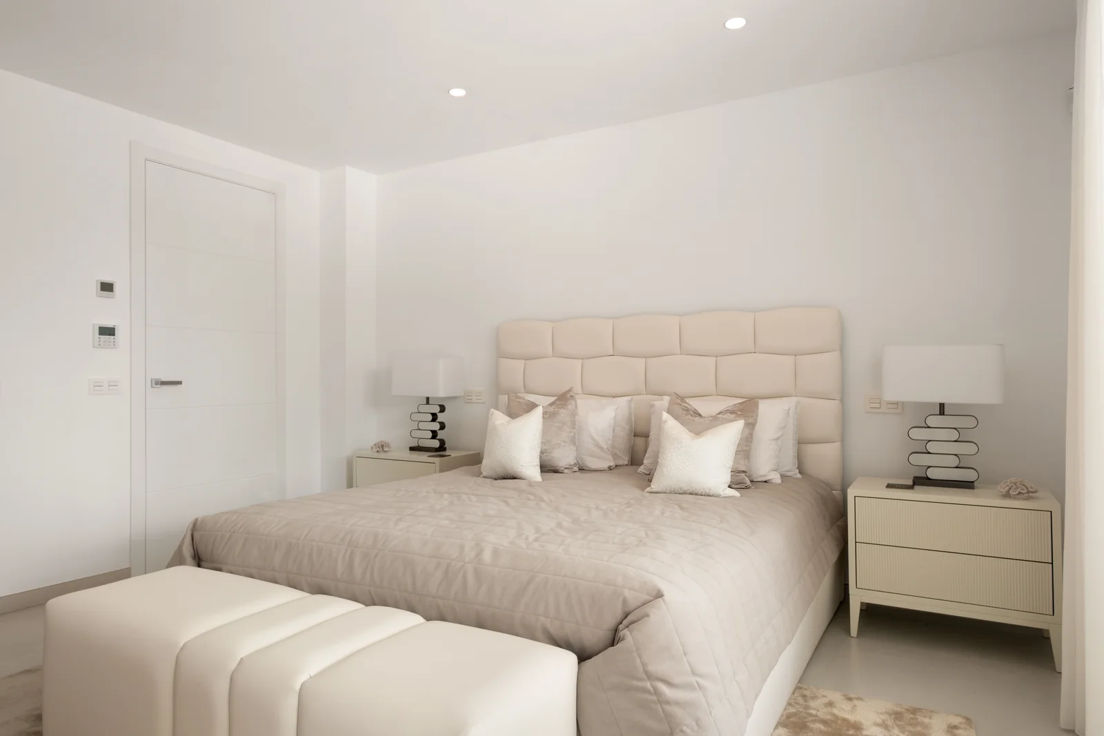 Buganville Villa bedroom with upholstered headboard and sea-facing view