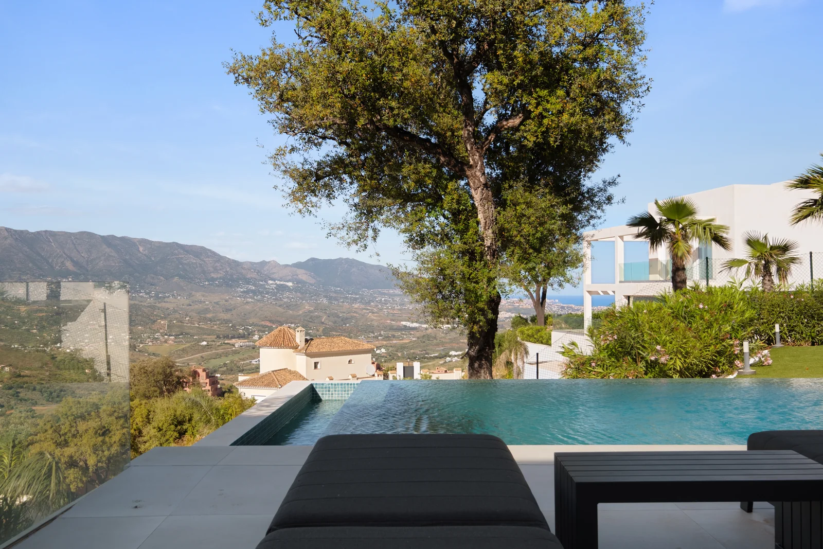 Buganville Villa pool edge with Mediterranean sea and mountain views, Marbella