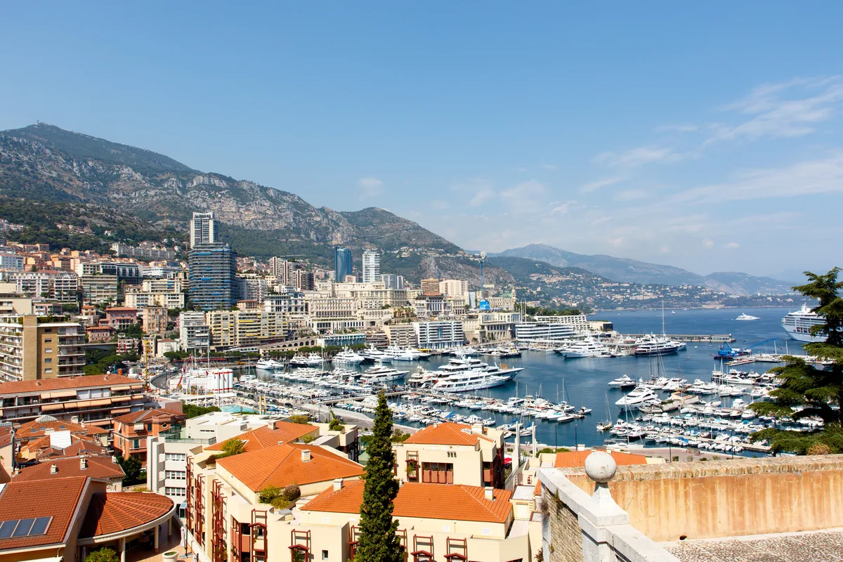 Monte Carlo harbor in Monaco with yachts and the city skyline in daylight