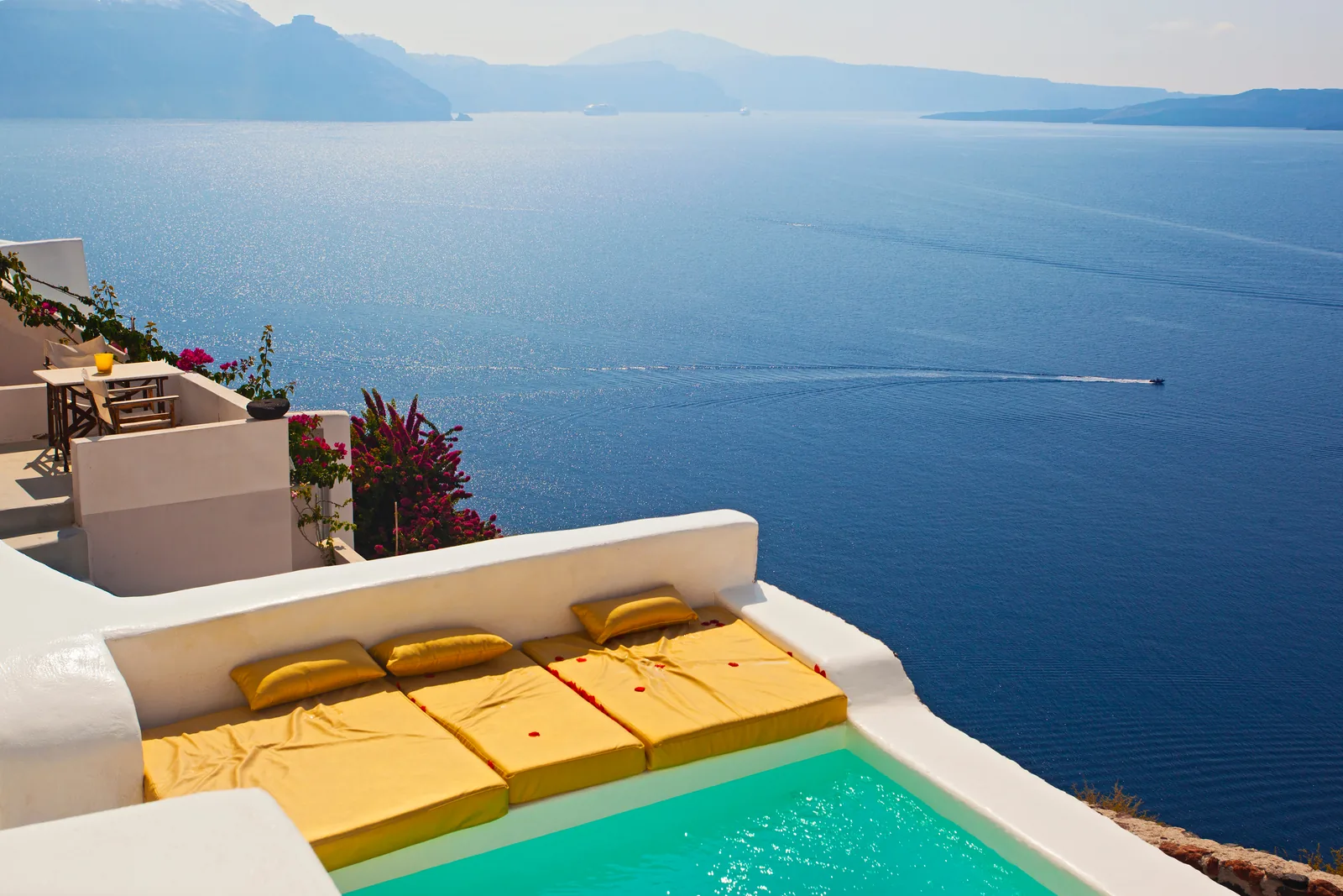 Private villa terrace and infinity pool above the Aegean caldera, Santorini, Greece
