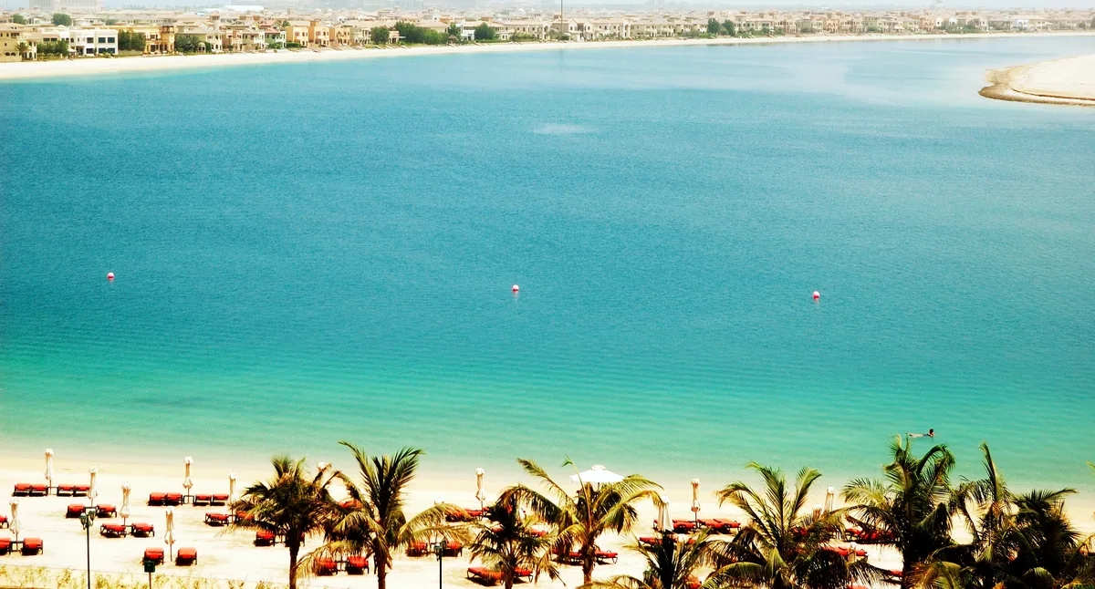 Waterfront villas across the turquoise lagoon of Palm Jumeirah, Dubai, a hub for cross-border property buyers