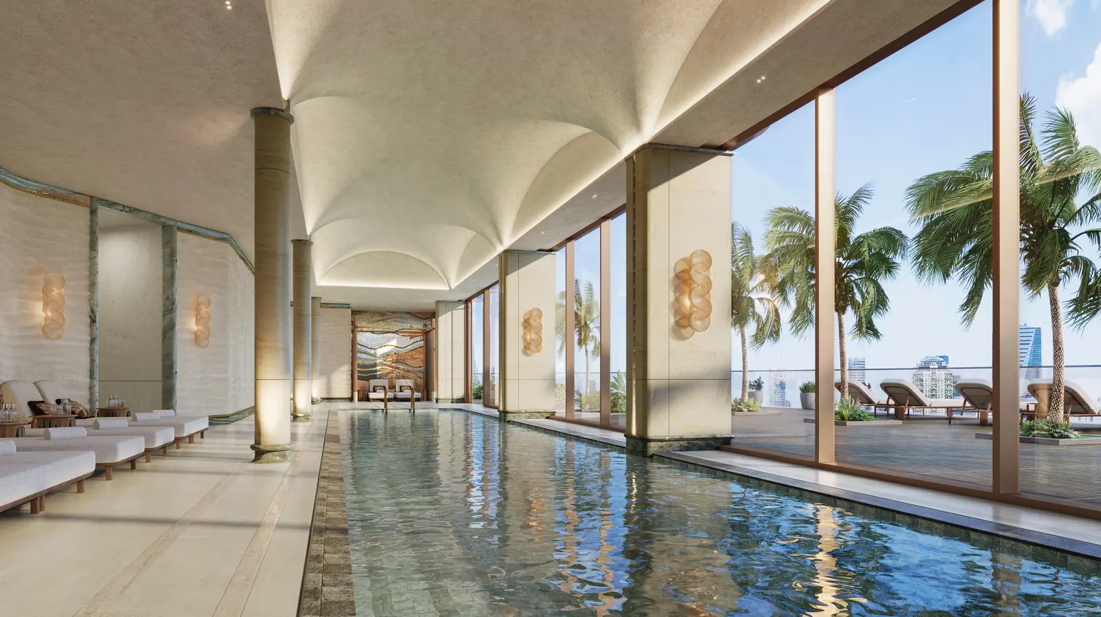 Jumeirah Residences indoor swimming pool with vaulted ceiling and palm-framed windows