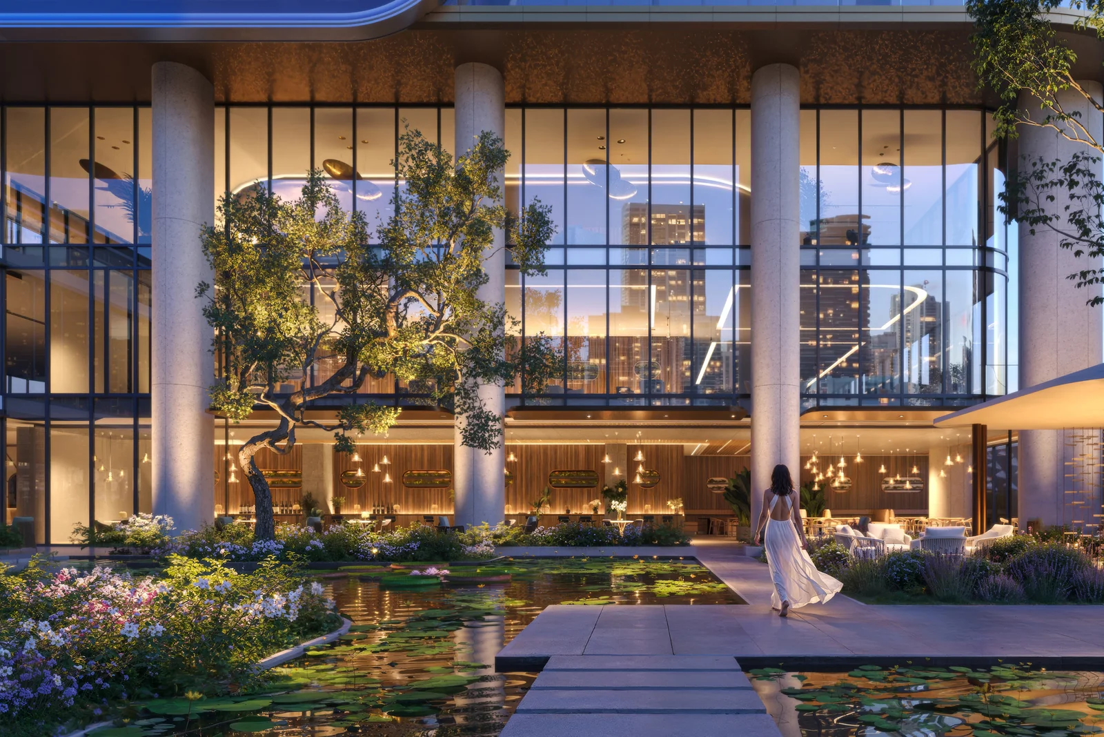 Anantara Residences Miami arrival garden with sculptural tree and double-height glazed lobby at dusk