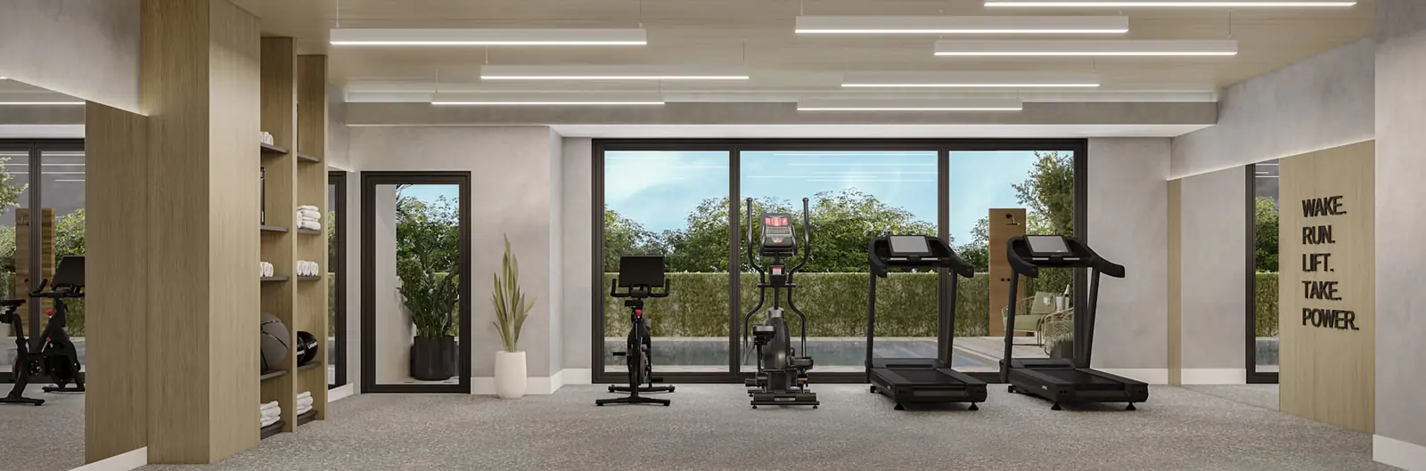 Botanic Residences fitness center cardio row facing full-height glazing onto the pool deck, Miami