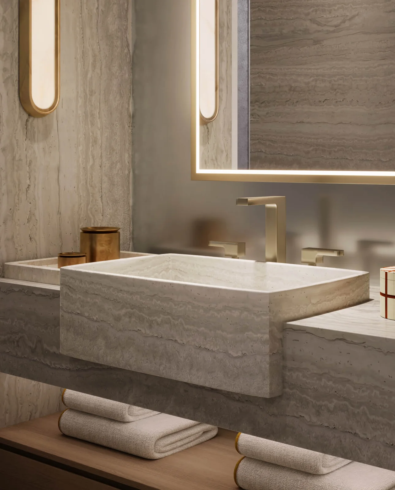 Banyan Tree Residences West Palm Beach travertine vanity with integrated stone sink and backlit mirror