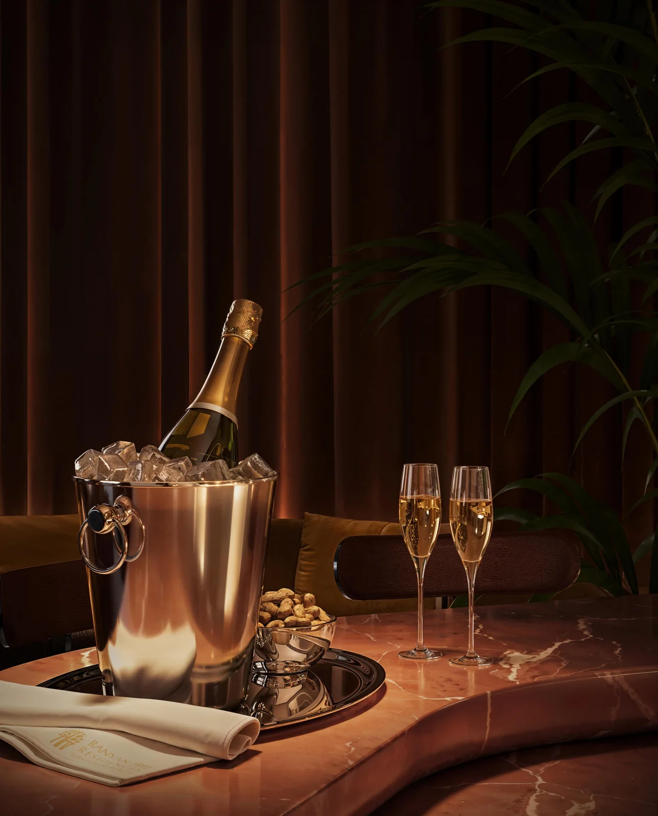 Banyan Tree Residences West Palm Beach lounge with champagne service on a red marble table