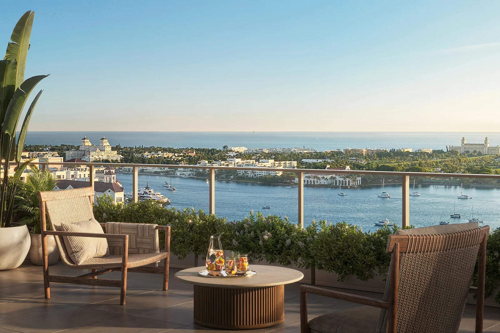 Banyan Tree Residences West Palm Beach private terrace with woven lounge chairs facing the Intracoastal Waterway