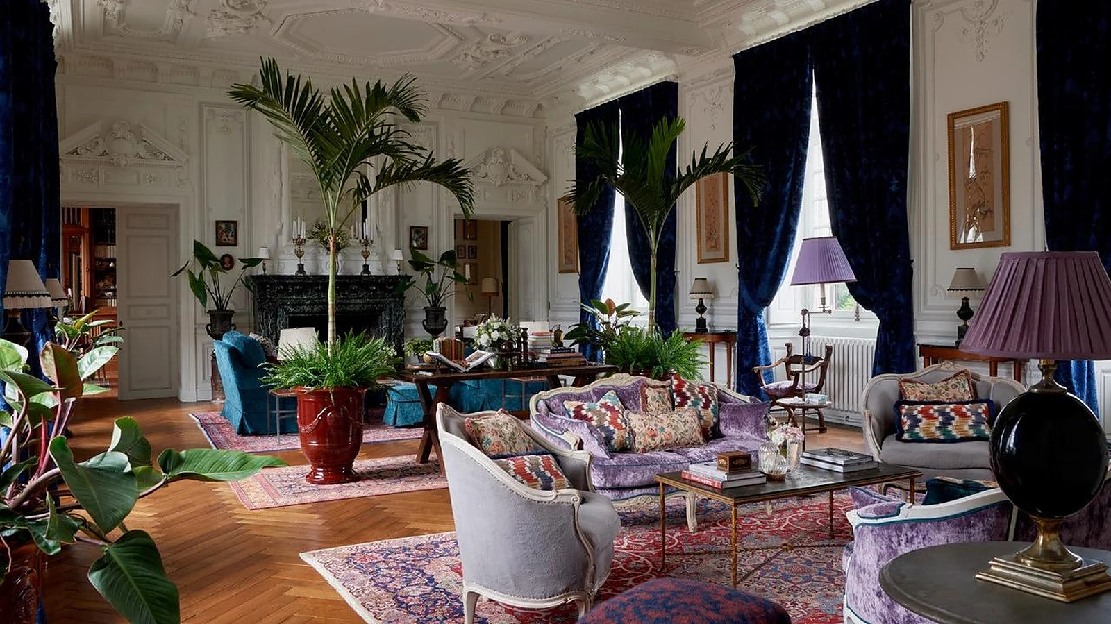 Private château estate grand salon with panelled walls, marble fireplace and herringbone parquet