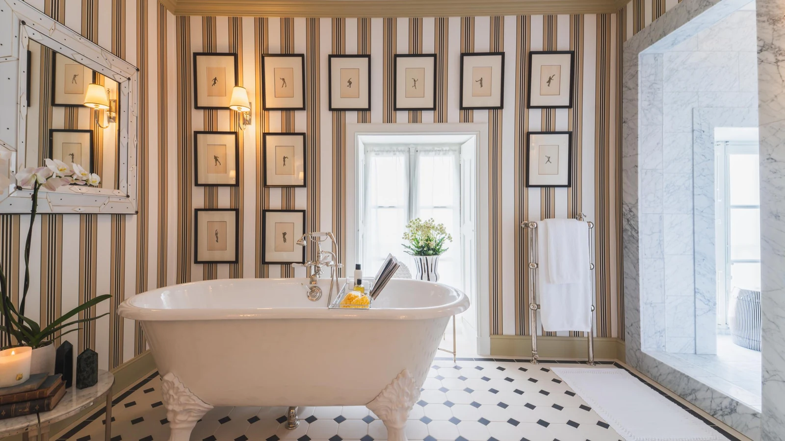 Private château estate bathroom with roll-top cast iron bath and marble walk-in shower
