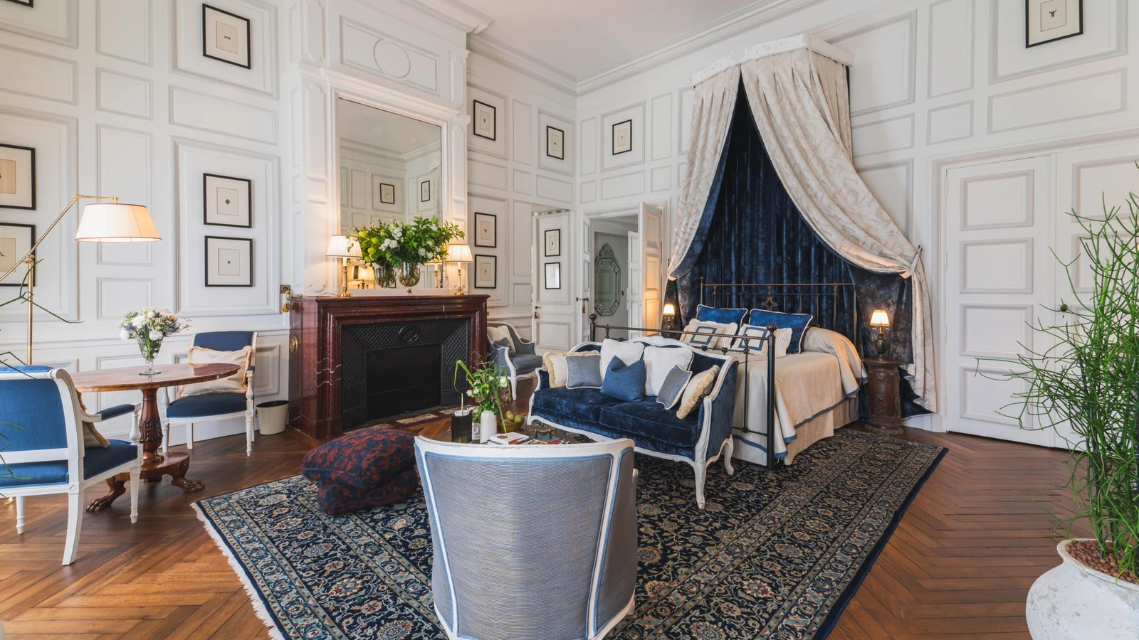 Private château estate principal bedroom with canopied bed and panelled walls