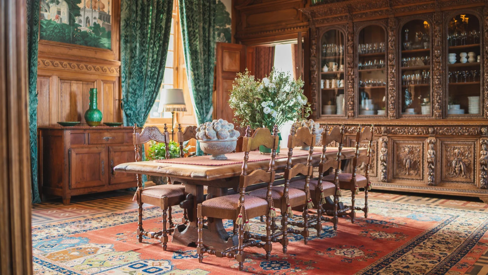 Private château estate dining room with carved oak dresser and painted panelling