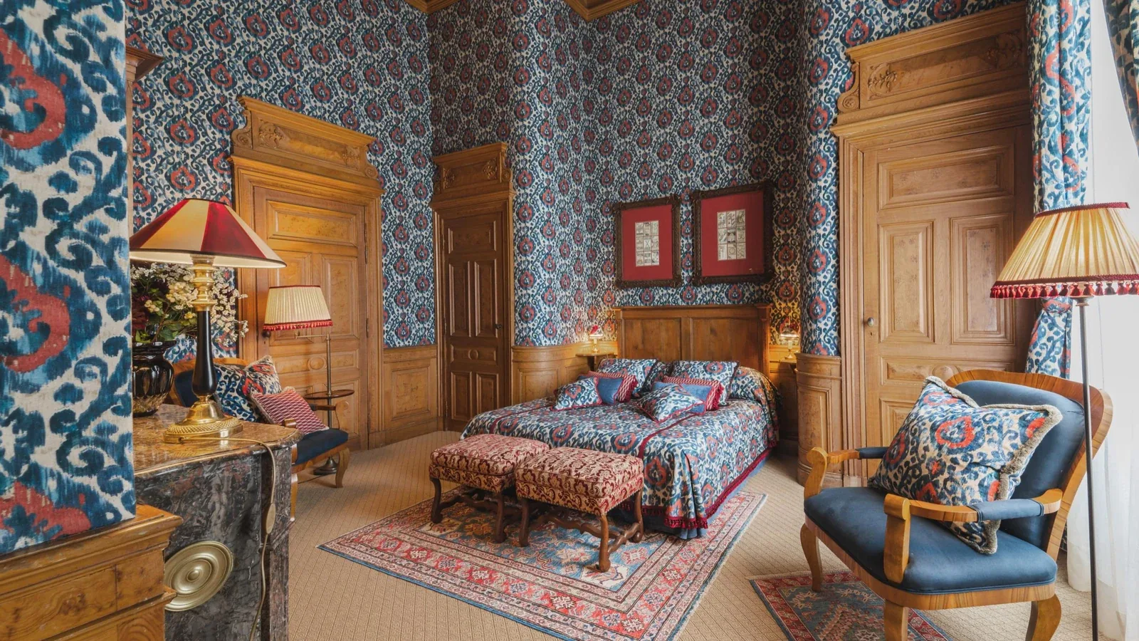 Private château estate bedroom with ikat wallcovering and burr walnut panelling