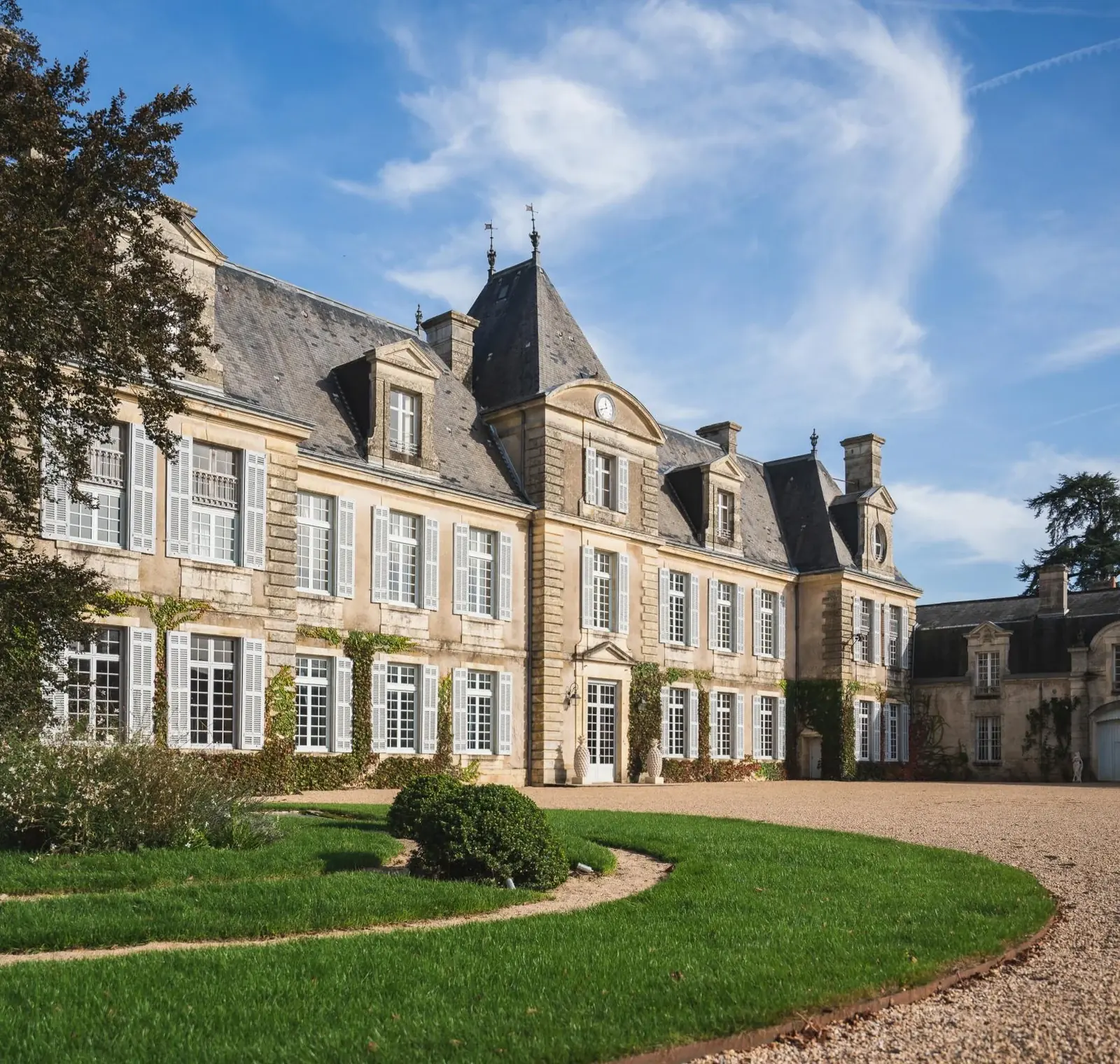 Private château estate front elevation with slate mansard roof and shuttered windows
