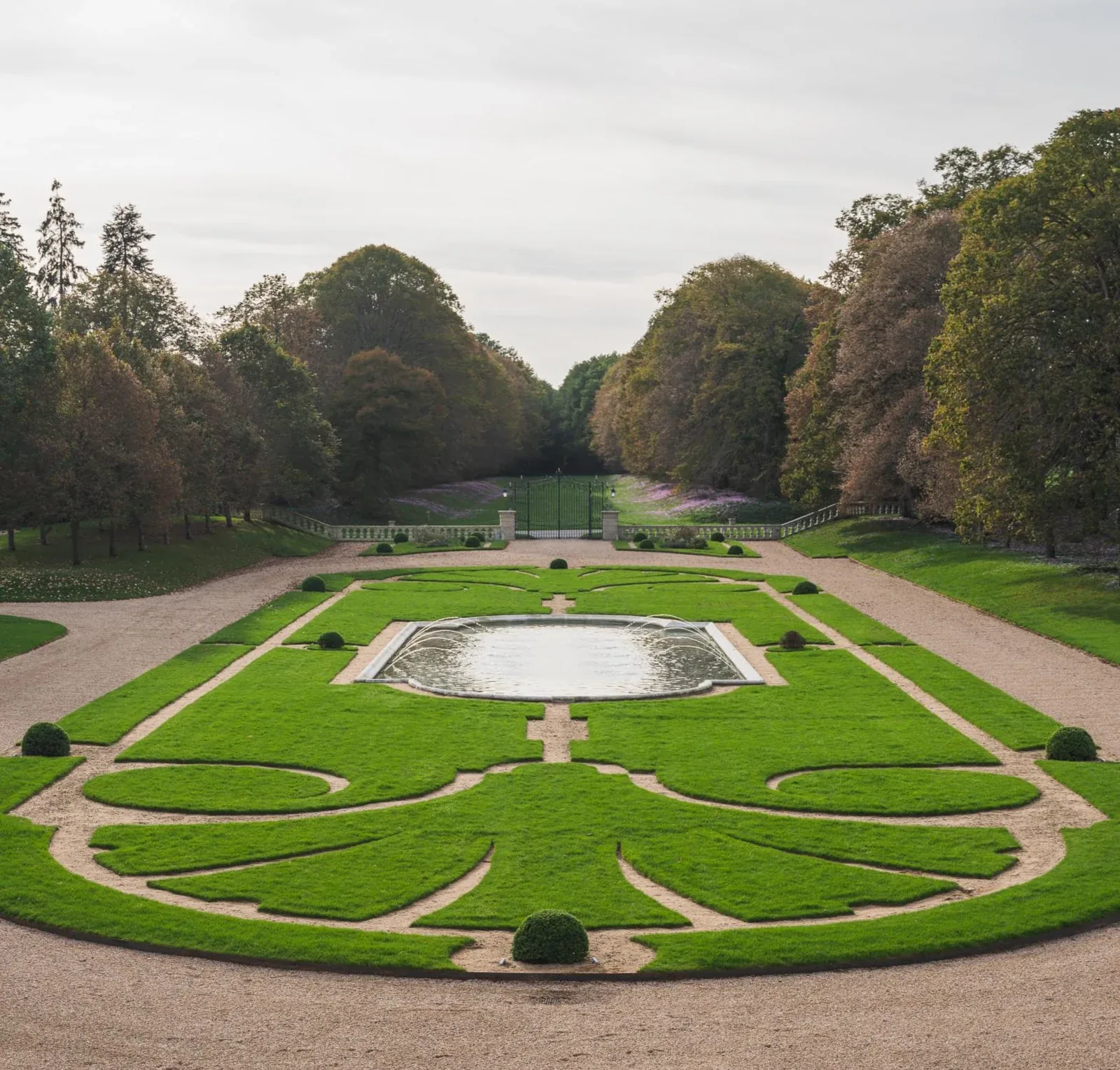 Private château estate formal parterre garden with mirror pool and clipped topiary