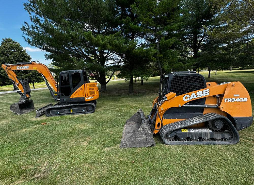 CASE excavator and compact track loader preparing a site on a lawn