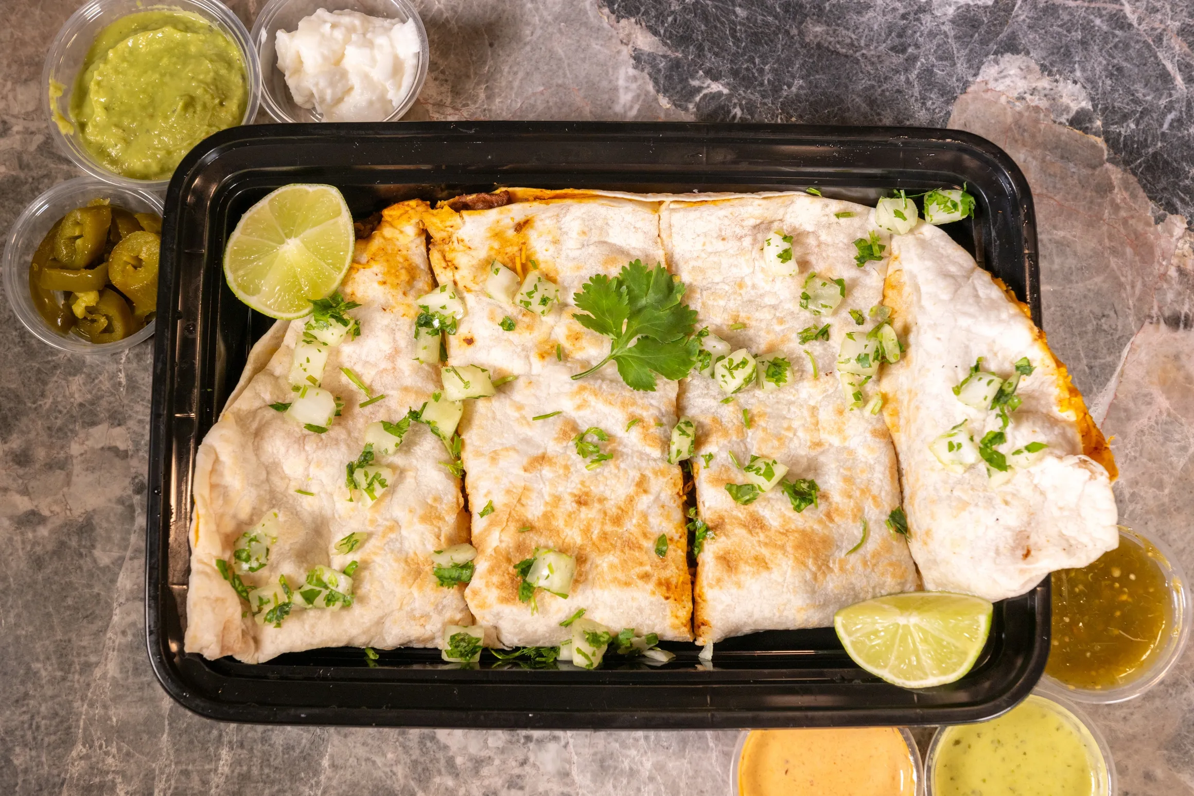 quesadilla of birria with 2 slices of lemon