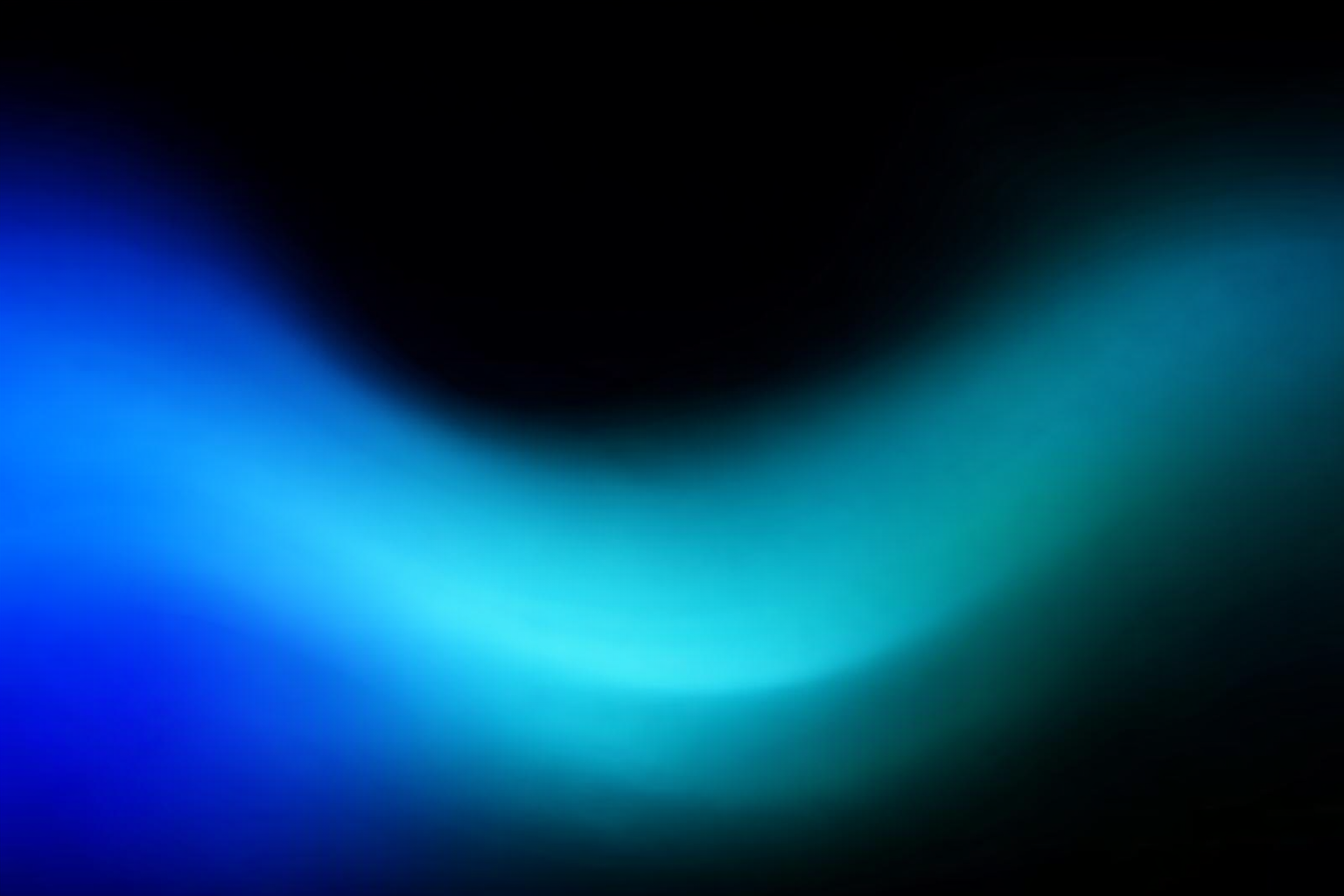 Abstract gradient with blue and teal shades blending into black background.