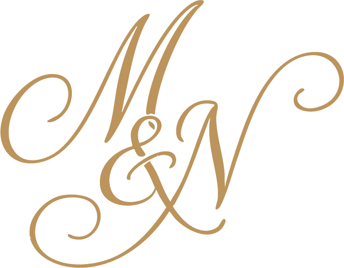 Stylized gold script monogram combining the letters M and N with an ampersand.