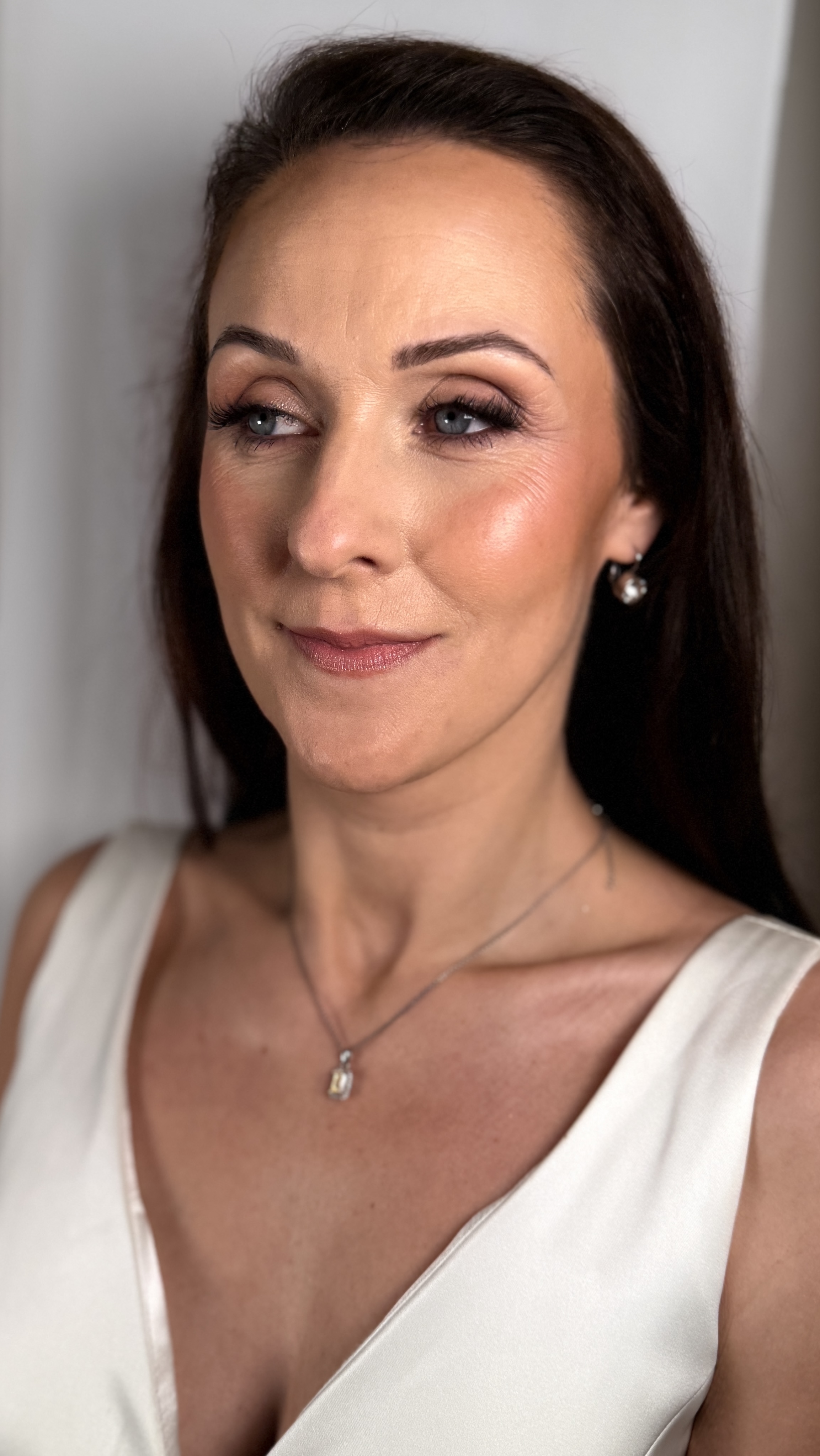Woman in bridal gown, with bridal makeup done by Ori Studio